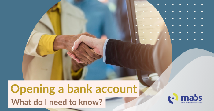 Cover blog image that states 'Opening a bank account - What do I need to know?'. Image in the center is of a person shaking hands with a bank employee.